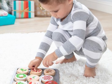 kid playing with Melissa & Doug Christmas cookie toys.