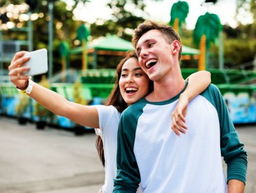 Young couple having fun together at an amusement park