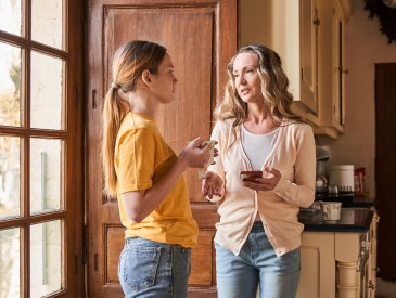 Adult woman and her daughter chatting with each other during the morning