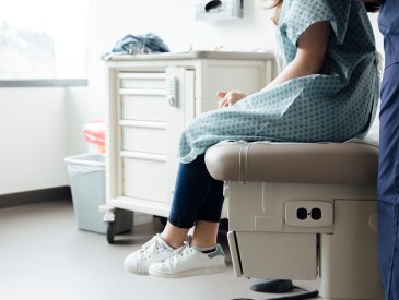 Girl sitting on exam table at doctor's office