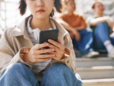 Teenage girl texting on phone