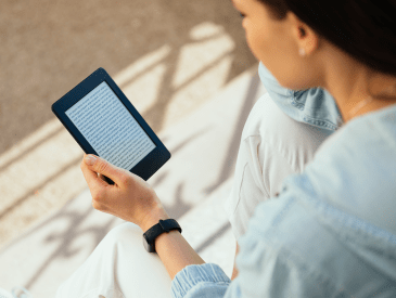 Woman reading from a kindle.